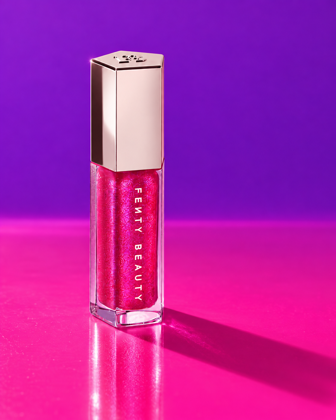 Fenty Beauty Gloss Bomb in electric fuchsia and violet